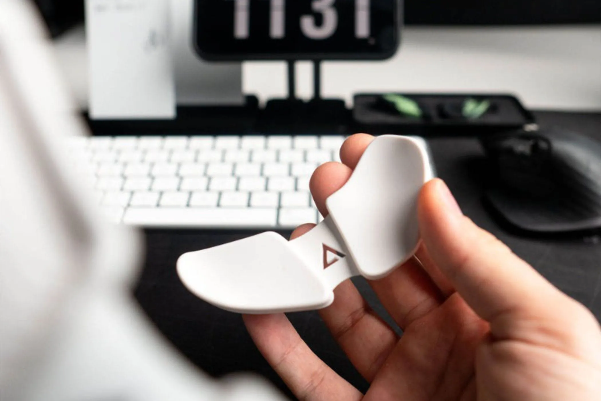 deltahub carpio carpal tunnel wrist rest held in a hand above an office desk