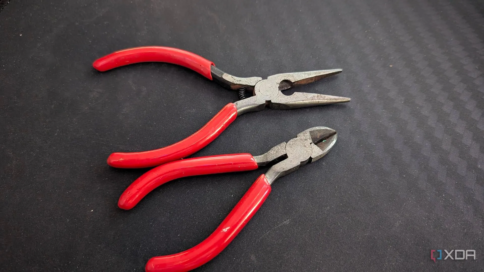 an image showing both needle nose and cutting pliers and a black mouse mat