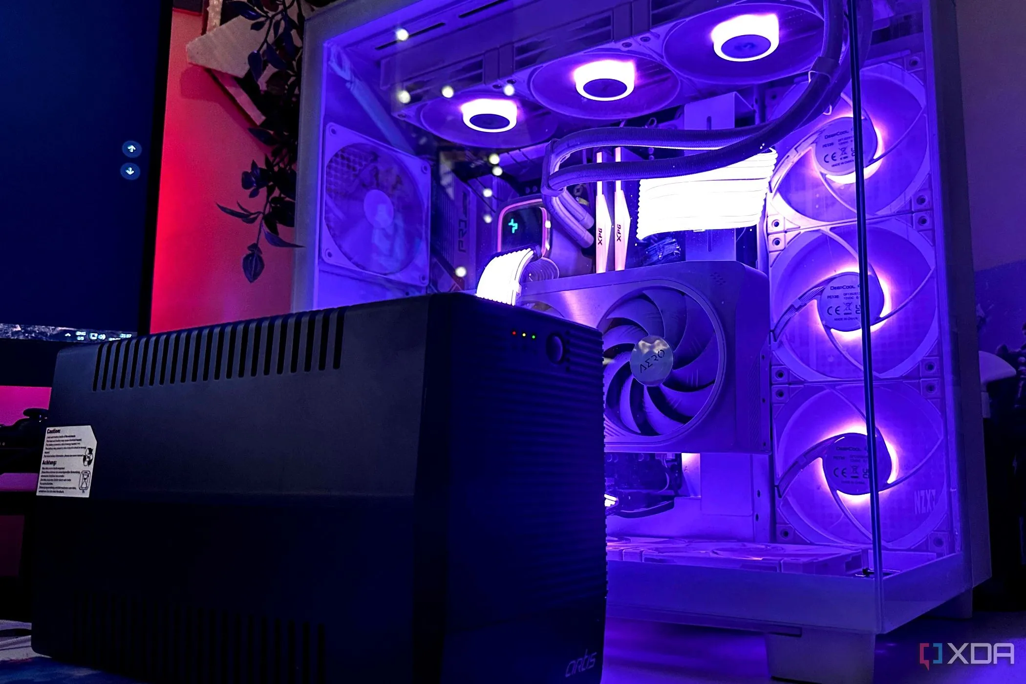 Bộ lưu điện UPS màu đen đặt cạnh thùng máy tính gaming, biểu tượng cho việc bảo vệ hệ thống khỏi sự cố điện và mất dữ liệu.
