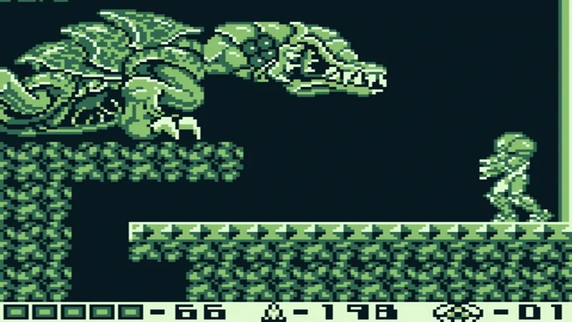 Cảnh chơi game từ Metroid II: Return of Samus trên hệ máy Game Boy, với đồ họa đơn sắc đặc trưng của dòng máy cầm tay.