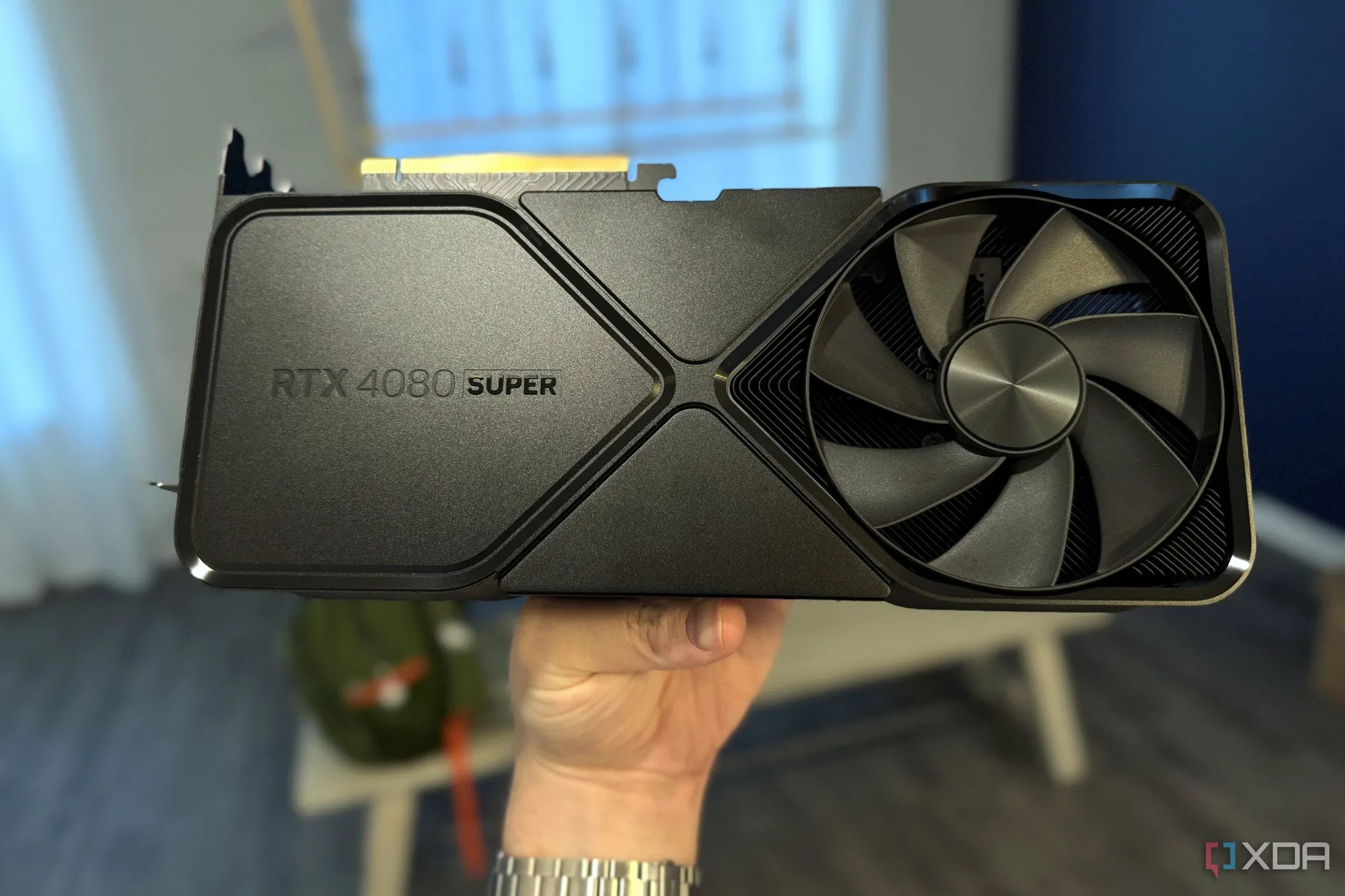 Card đồ họa Nvidia GeForce RTX 4080 Super FE cầm trên tay trong phòng ăn