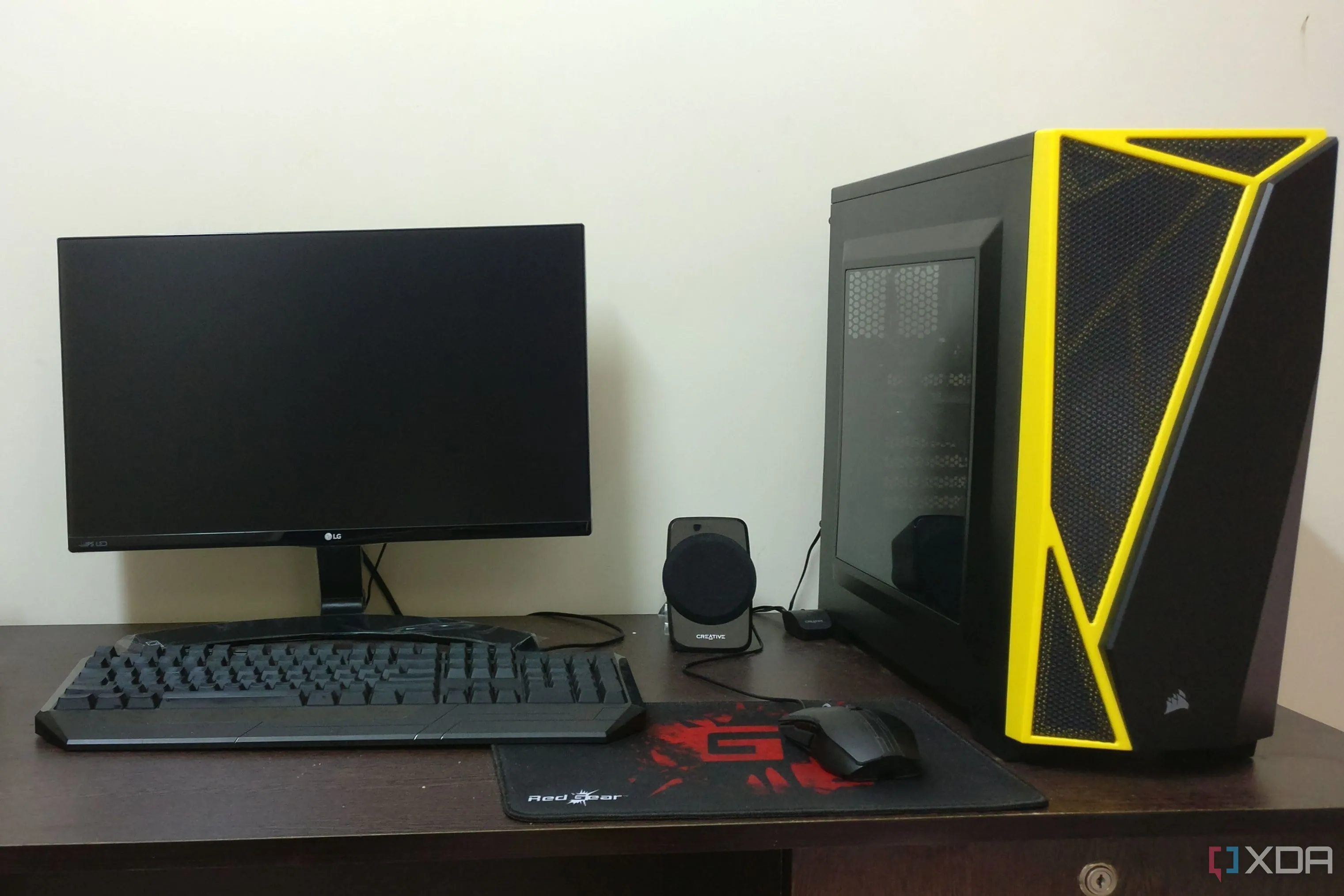 Góc làm việc với bộ PC gaming màu đen kèm màn hình, bàn phím và chuột, minh họa chi phí tổng thể của dàn máy tính