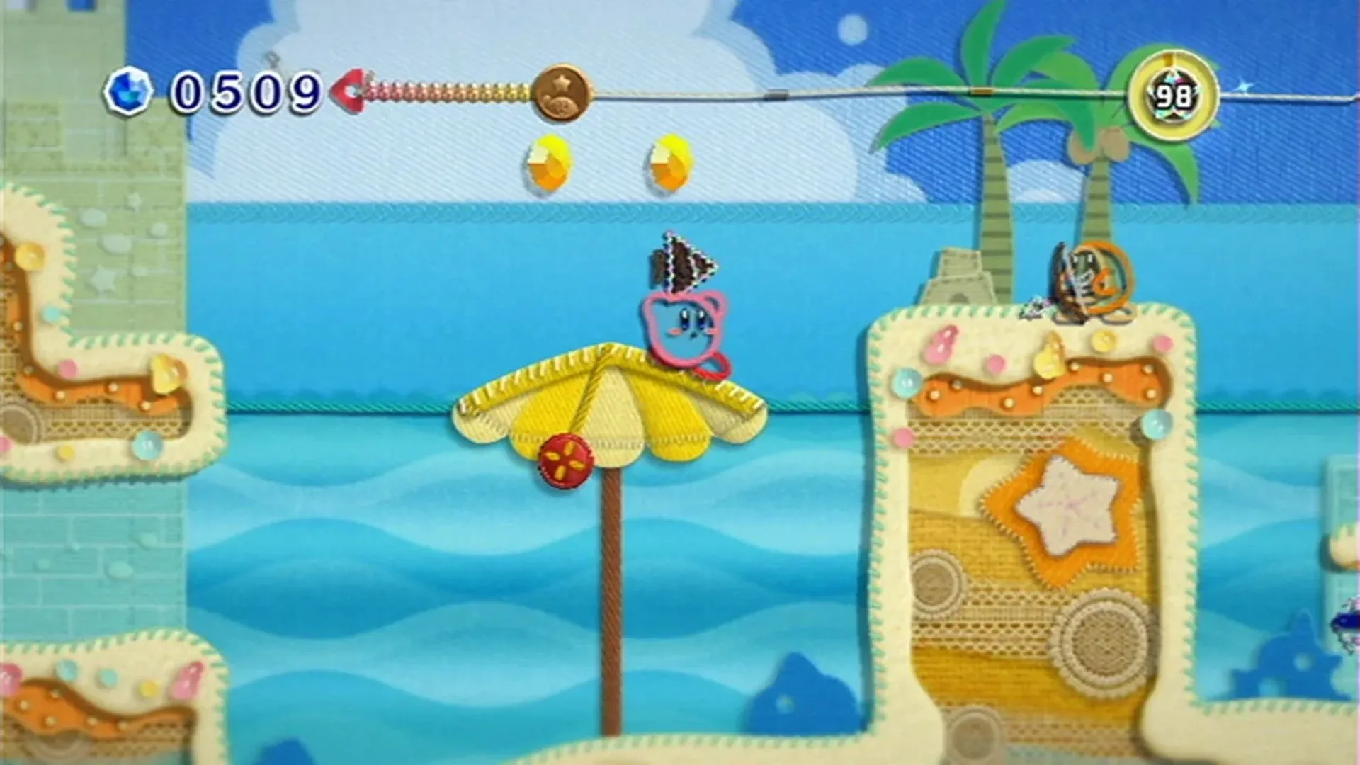 Hình ảnh Kirby khám phá thế giới len sợi đầy màu sắc trong game Kirby's Epic Yarn trên Nintendo Wii
