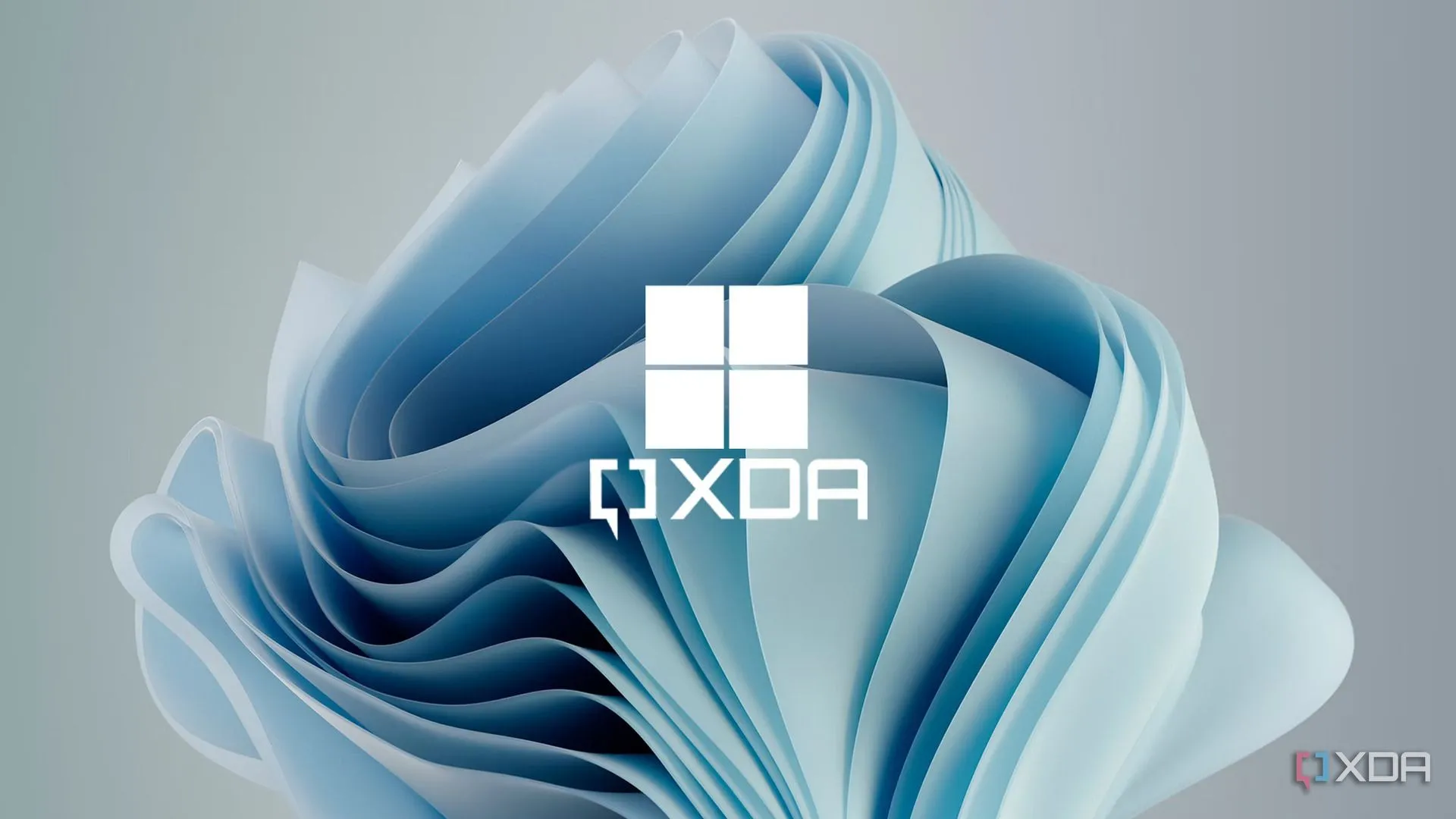 Hình nền Windows 11 màu xanh với logo XDA mờ, cài đặt độ sáng được tô sáng