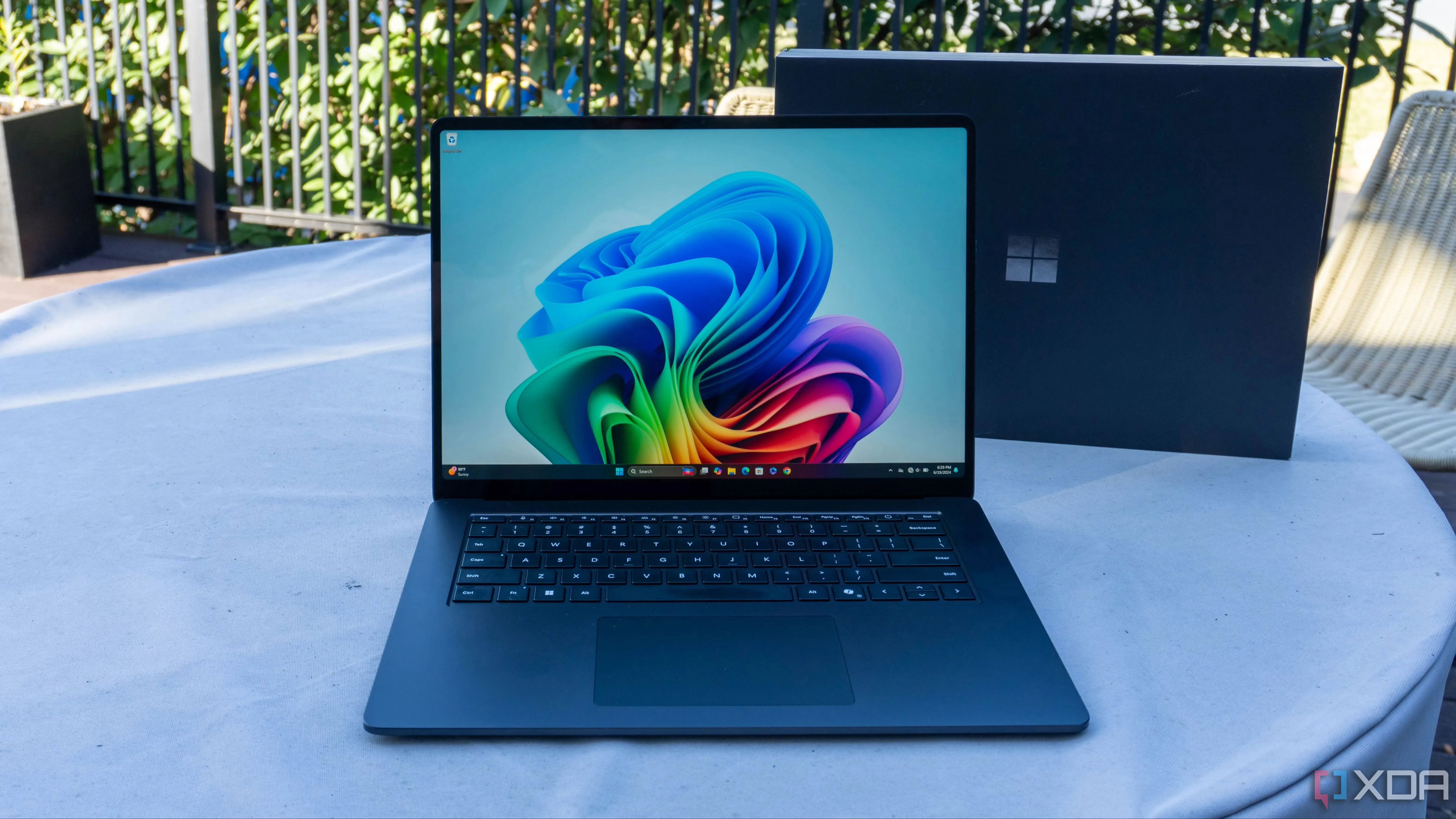 Máy tính xách tay Surface Laptop chạy Windows 11 trên bàn, minh họa cho việc cần tối ưu hóa hệ điều hành.