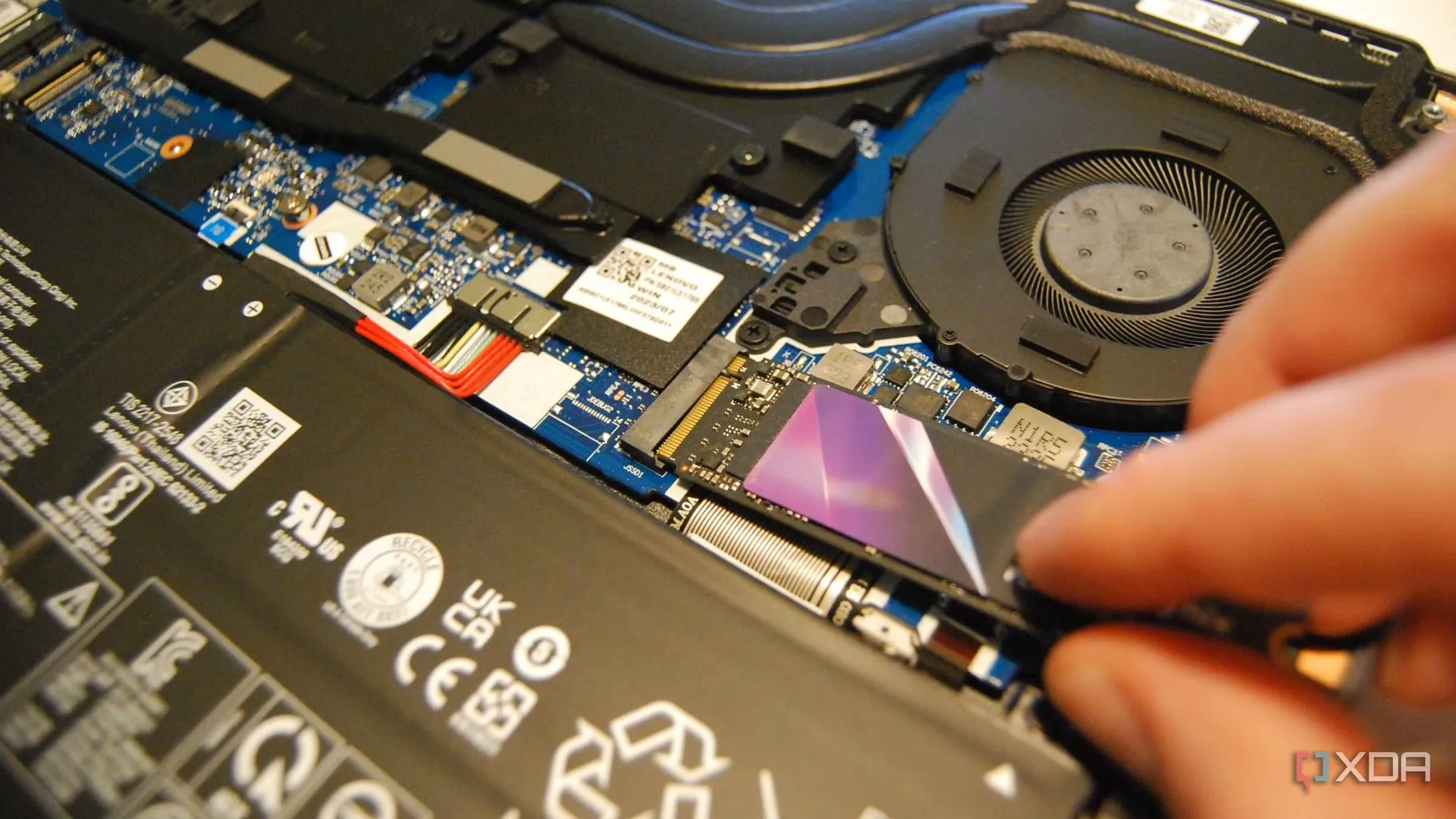Người đang lắp ổ đĩa M.2 vào laptop