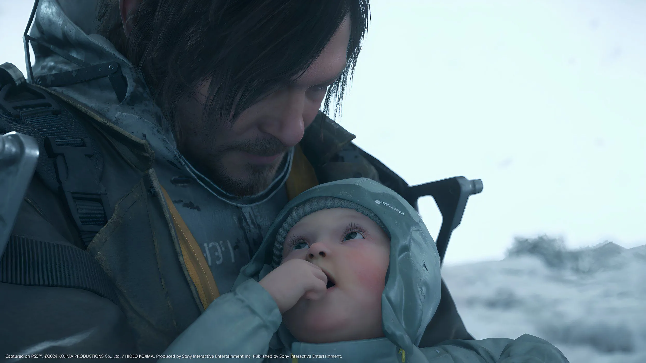 Sam Porter Bridges mang theo BB trong Death Stranding 2: On The Beach, khám phá thế giới hậu tận thế.