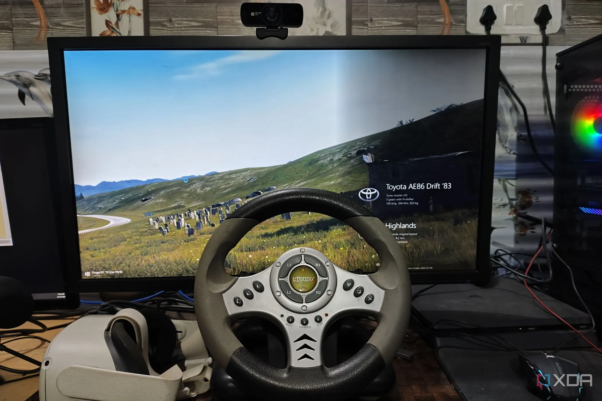 Thiết bị chơi game thực tế ảo Meta Quest 2 cùng vô lăng đua xe, minh họa khả năng mod game flat screen sang VR như Assetto Corsa